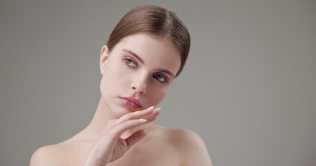 Beauty, health, cosmetics, anti-aging therapy and skin care concept - young beautiful brunette Caucasian woman looking at the camera in a bad mood, upset and disappointed