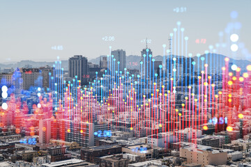 San Francisco skyline overlaid with colorful holographic data bars on a city and urban background. Future technology and business concept. Double exposure