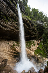 Perichnik waterfall is a beautiful drop from the mountain cliff, in Triglav National Park. Slovenian waterfall. Long for walking and trekking, enter inside the cave to admire it. Power and majesty.