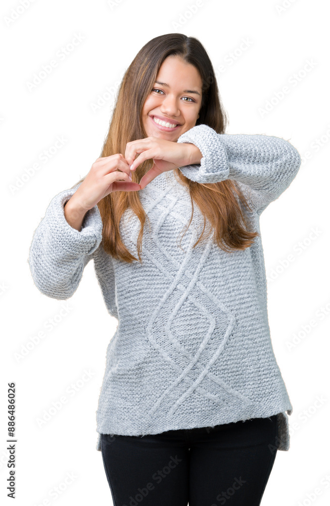 Canvas Prints Young beautiful brunette woman wearing sweater over isolated background smiling in love showing heart symbol and shape with hands. Romantic concept.