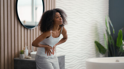 Sad African American woman girl female bathroom home feel bad unhealthy sick menstrual pain painful...
