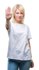 Obraz premium Young beautiful blonde woman wearing white t-shirt over isolated background doing stop sing with palm of the hand. Warning expression with negative and serious gesture on the face.