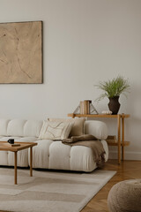 Cosy and stylish interior design of living room with modular white sofa, wooden furnitures, paintings on the wall, decorations and personal accessories. Home styling. Template.