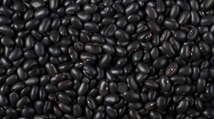 Black beans scattering, each bean highlighting its dark, glossy texture and robust flavor