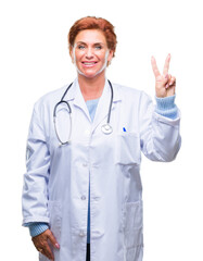 Senior caucasian doctor woman wearing medical uniform over isolated background showing and pointing up with fingers number two while smiling confident and happy.