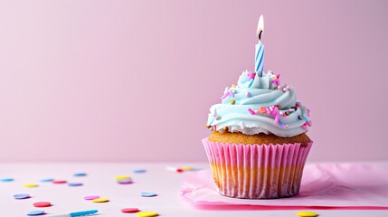 festive candle cupcake on a plain background with space for copying