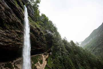 Perichnik waterfall is a beautiful drop from the mountain cliff, in Triglav National Park. Slovenian waterfall. Long for walking and trekking, enter inside the cave to admire it. Power and majesty.