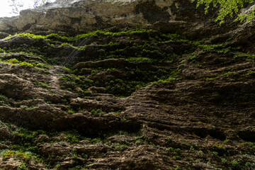 Obraz premium Perichnik waterfall is a beautiful drop from the mountain cliff, in Triglav National Park. Slovenian waterfall. Long for walking and trekking, enter inside the cave to admire it. Power and majesty.