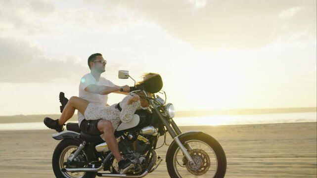 A couple rides a motorcycle along the beach at sunset, creating cherished memories of their adventure and lovefilled journey, enjoying the freedom of exploring the coastline