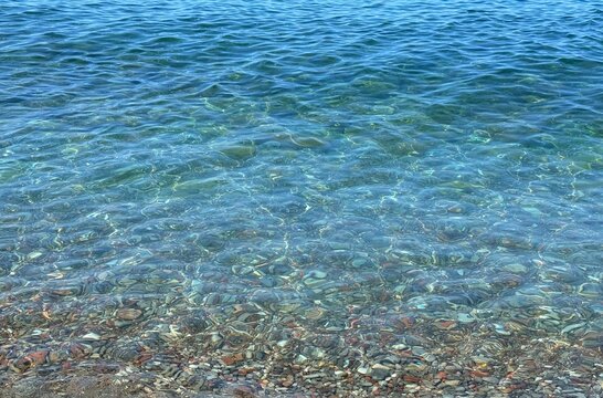 Blue sea clear waves on pebble beach 