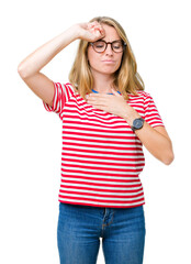 Fototapeta premium Beautiful young woman wearing glasses over isolated background Touching forehead for illness and fever, flu and cold, virus sick
