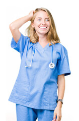 Beautiful young doctor woman wearing medical uniform over isolated background Smiling confident touching hair with hand up gesture, posing attractive