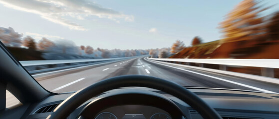 Obraz premium A dynamic view from inside a car moving swiftly along an empty highway, surrounded by autumnal trees under a clear sky.
