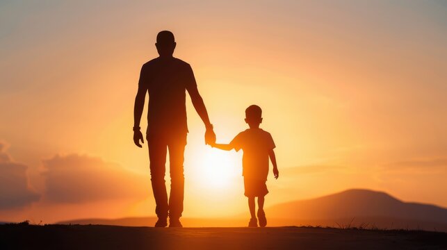 Silhouette of a father and son holding hands, walking towards a beautiful sunset, representing family bonding and togetherness.