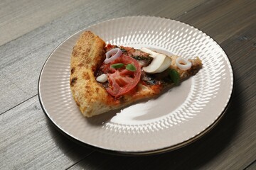 Piece of tasty pizza with mushrooms, basil and tomato on wooden table