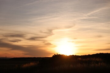 Picturesque view of countryside under beautiful sky at sunset
