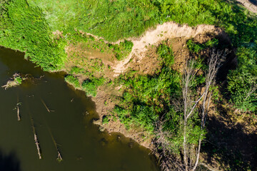 Drone view of an eroded river bank with a landslide