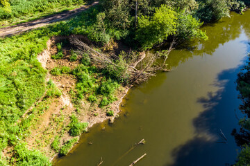 Drone view of an eroded river bank with a landslide