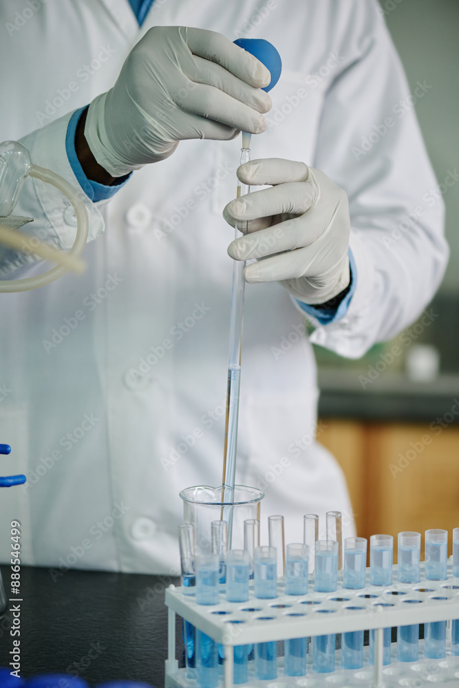 Poster gloved hands of modern chemist or researcher in lab coat dropping liquid substance through glass pip