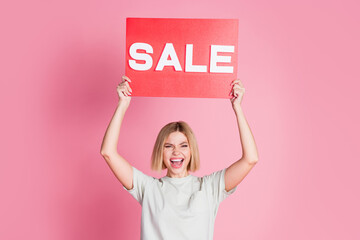 Photo of lovely cheerful nice girl wear trendy grey clothes hands hold card offer sale isolated on...