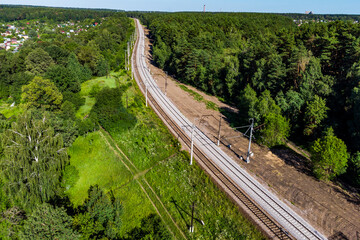 View of an electrified railway stretching into the distance in the countryside