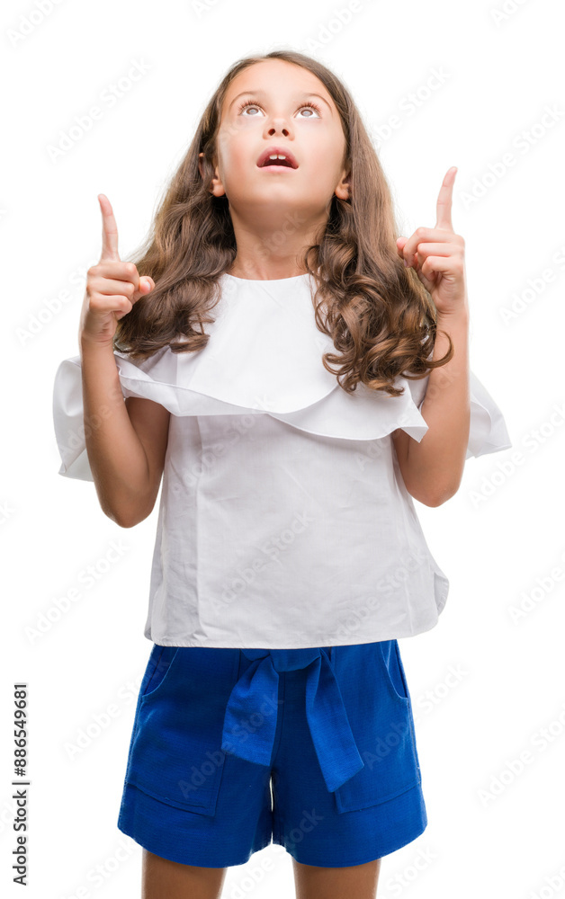 Canvas Prints brunette hispanic girl amazed and surprised looking up and pointing with fingers and raised arms.