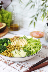 A bowl with a salad made of green vegetables