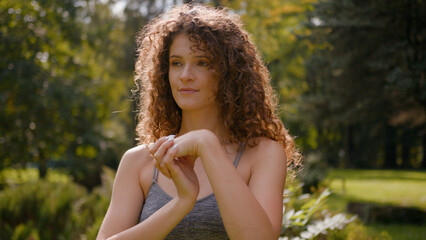 Caucasian young woman fit girl fitness lady female sportswoman warming up wrist joints twist palms...