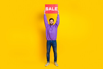 Full size photo of handsome young guy raise hold sale plate wear trendy violet outfit isolated on...