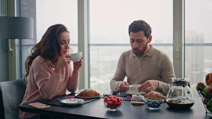 Happy couple drinking coffee at city view kitchen home closeup. Spouses leisure