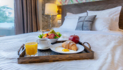 Traditional romantic breakfast in bed in white and beige bedroom