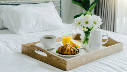 Wicker tray with continental breakfast on white bed sheets