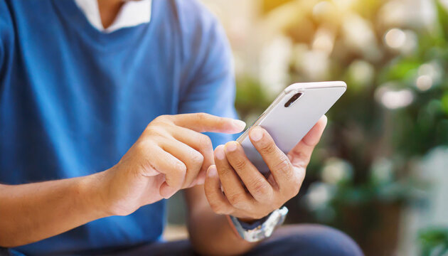 close up hand hold mobile cell phone device:focus on man play on smartphone concept