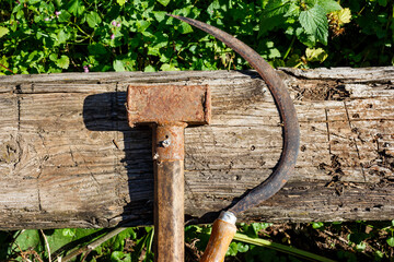 Rusty worker tools lying nearby - hammer and sickle