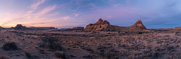 Obraz premium Sunset Over a Desert Landscape with Dramatic Rock Formations