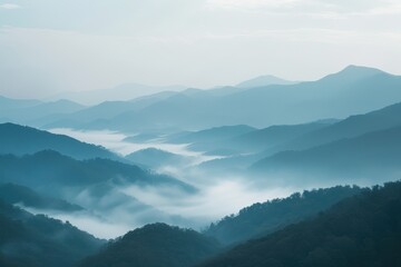 Obraz premium Misty mountain landscape with blue sky.
