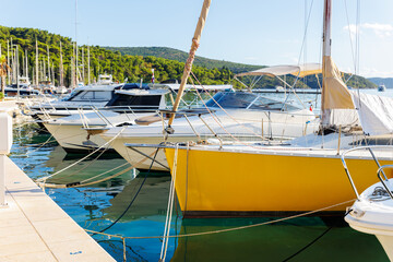 Side view modern luxury sailboat in turquoise sea ocean water marina bay harbor. Sail boat rental charter berth docking service. Nautical adventure travel lifestyle. Cruise trip vacation