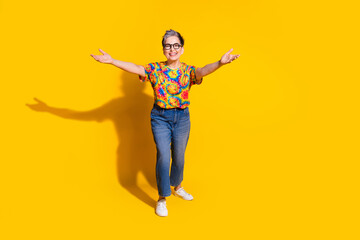 Photo of glad cheerful senior woman wear trendy clothes open hands hugging isolated on yellow color background