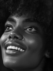 A portrait of a woman with a warm smile, taken in black and white