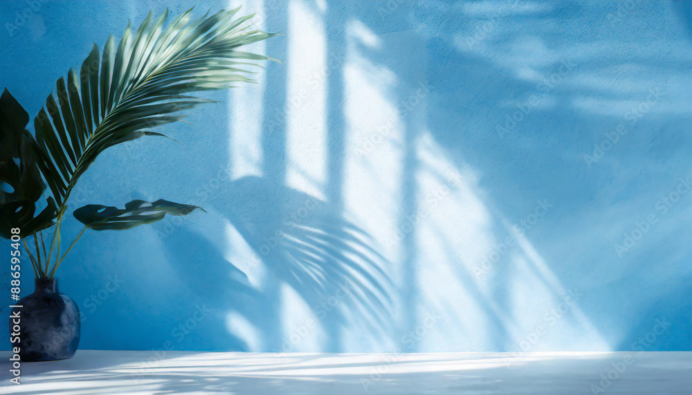 Poster blurred shadow from palm leaves on the light blue wall. minimal abstract background for product pres