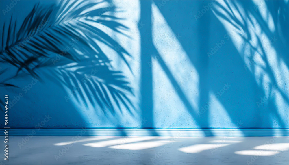 Poster blurred shadow from palm leaves on the light blue wall. minimal abstract background for product pres