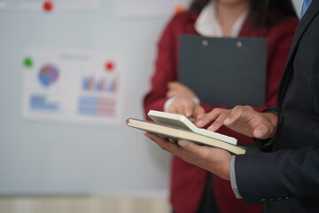 Meeting of business people to analyze and discuss and brainstorm. data chart financial report financial advisor Teamwork and close-up image accounting concept.