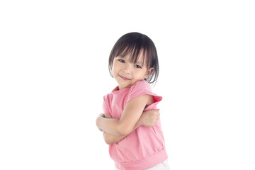 A cute Asian little girl stands with her arms folded and smiling happily isolated on white background with clipping paths.