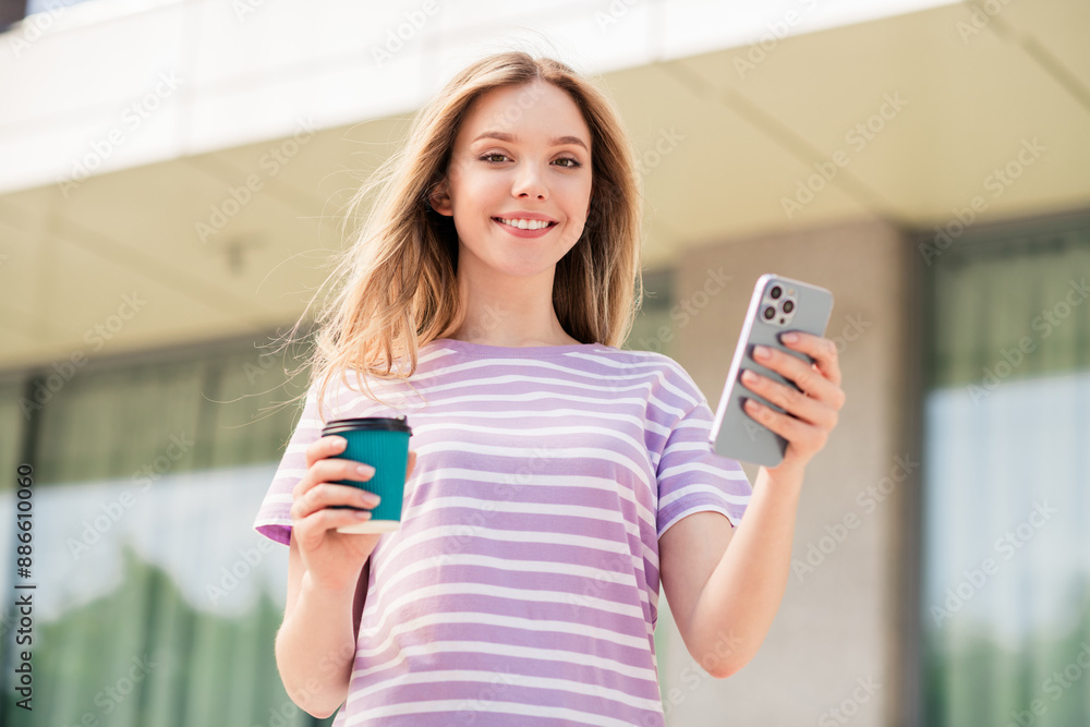 Poster photo of pretty cheerful lady wear violet t-shirt chatting modern device enjoying drinking beverage 