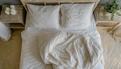Top view of unmade bedding sheets and pillow ,Unmade messy bed after comfortable sleep concept