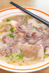 angle view beef balls and pork offal with Guilin rice noodles at vertical composition