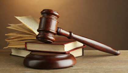 Wooden gavel and books on wooden table, law concept