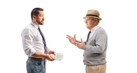 Businessman holding money and talking to an elderly man