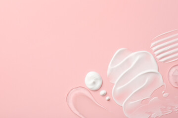 Samples of face cream on pink background, top view. Space for text