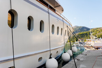 Close-up detail side view big luxury cruise yacht boat moored at Croatian bay harbor moored at...